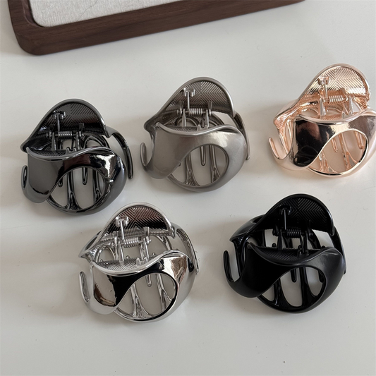 New design with a metallic mid-sized hollowed-out hair clip for half-up hairstyles, featuring a shark clip texture.