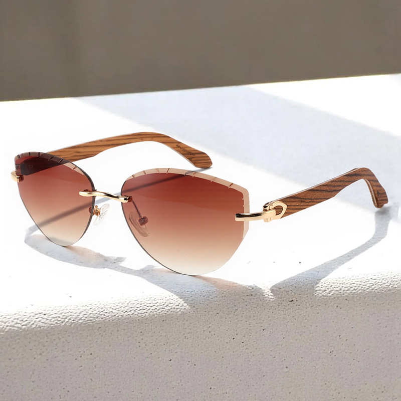 Frameless sunglasses, stylish cat-eye design, lenses cut with wood-paneled temples.