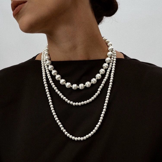 Round, brushed finish clavicle chain earrings with a unique design, exuding a sophisticated and luxurious feel. A long, intricately crafted sweater chain.