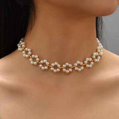 A luxurious three-piece set of pearl necklace, bracelet, and earrings with a bohemian design.