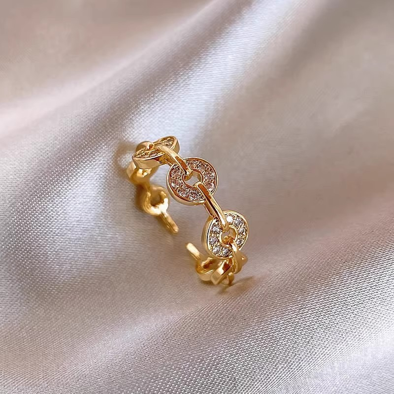 A trendy, small-scale design ring for women – an open-ring finger ring designed to be worn on the index finger, resembling a copper coin.