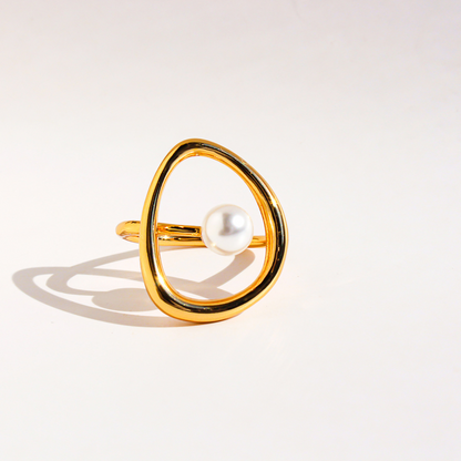 A stylish, abstract pearl ring with a copper-plated, genuine-gold finish and a unique, hollowed-out curved design.