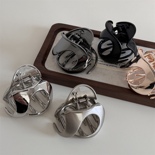 New design with a metallic mid-sized hollowed-out hair clip for half-up hairstyles, featuring a shark clip texture.